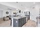 This kitchen features an island with seating, granite countertops, stainless appliances, and white cabinetry at 4840 Baines Loop Rd, Spring Hope, NC 27882