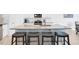 This kitchen features an island with seating, granite countertops, stainless appliances, and white cabinetry at 4840 Baines Loop Rd, Spring Hope, NC 27882