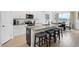 This kitchen features an island with seating, granite countertops, stainless appliances, and white cabinetry at 4840 Baines Loop Rd, Spring Hope, NC 27882