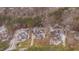 Expansive aerial view showcasing a neighborhood with well-manicured lawns and lush green trees at 659 Willard Dr, Creedmoor, NC 27522