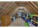Bright attic featuring unfinished walls, wood beams, and ample storage space; perfect for organizing and accessing belongings at 659 Willard Dr, Creedmoor, NC 27522