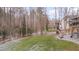 Spacious backyard featuring a well-manicured lawn, a stone patio with seating, and a wooded backdrop at 659 Willard Dr, Creedmoor, NC 27522