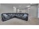 Spacious finished basement featuring a black leather sectional and neutral carpet at 659 Willard Dr, Creedmoor, NC 27522