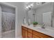 Bathroom with double sink vanity with a framed mirror and a shower-tub combination at 659 Willard Dr, Creedmoor, NC 27522