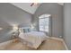 Cozy bedroom featuring vaulted ceiling, carpet flooring, and natural light from a large window at 659 Willard Dr, Creedmoor, NC 27522