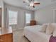 Bright bedroom featuring neutral decor, plush carpeting, and natural light from two windows at 659 Willard Dr, Creedmoor, NC 27522