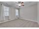 Bright bedroom featuring neutral carpet, white trim and a ceiling fan at 659 Willard Dr, Creedmoor, NC 27522