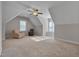 Spacious bonus room with neutral carpeting, two chairs and natural light from multiple windows at 659 Willard Dr, Creedmoor, NC 27522