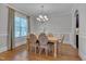 Dining room boasts hardwood floors, natural light, and a stylish chandelier at 659 Willard Dr, Creedmoor, NC 27522