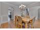 Elegant dining room features a chandelier, wood floors, trim detail and seating for six at 659 Willard Dr, Creedmoor, NC 27522
