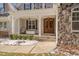 Inviting front porch features comfortable seating and stone accents at 659 Willard Dr, Creedmoor, NC 27522