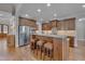 Well-equipped kitchen featuring an island with seating, granite countertops, and stainless steel appliances at 659 Willard Dr, Creedmoor, NC 27522