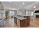 Open concept kitchen, stainless appliances, granite countertops, an island, and hardwood floors at 659 Willard Dr, Creedmoor, NC 27522
