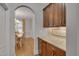 Granite counters and wood cabinets complement the dining room archway and hardwood floors at 659 Willard Dr, Creedmoor, NC 27522