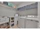 Organized laundry room featuring a utility sink, washer, dryer and shelving units for storage at 659 Willard Dr, Creedmoor, NC 27522
