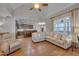 Open living room flows into the kitchen, with a sectional sofa, hardwood floors, and natural light at 659 Willard Dr, Creedmoor, NC 27522