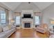 Bright living room features a cozy fireplace, large windows, and comfortable seating at 659 Willard Dr, Creedmoor, NC 27522