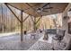 Outdoor covered patio with stone flooring, a ceiling fan and comfortable furniture at 659 Willard Dr, Creedmoor, NC 27522