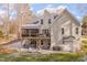 Rear exterior view of home showing multi-tiered patio and landscaped yard at 659 Willard Dr, Creedmoor, NC 27522
