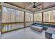 Relaxing screened porch with wooded views, comfortable seating, and stylish ceiling fan at 659 Willard Dr, Creedmoor, NC 27522