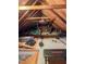 Spacious attic with exposed beams, exercise equipment, and natural light at 701 Grandview Drive Dr, Durham, NC 27703