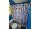 Blue bathroom featuring a shower with curtain, toilet, and patterned shower curtain at 701 Grandview Drive Dr, Durham, NC 27703