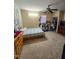 Neutral bedroom featuring a cozy bed, a ceiling fan, natural light, and ample closet space at 701 Grandview Drive Dr, Durham, NC 27703