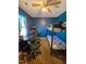 Bedroom featuring a bunkbed, desk, ceiling fan, and blue walls at 701 Grandview Drive Dr, Durham, NC 27703