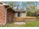 Inviting back deck with sliding glass doors and steps leading to a brick and stone walkway at 714 W J St, Erwin, NC 28339