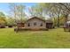 Home's backyard view showcases a spacious wood deck, a lush lawn, and a cozy ambiance for outdoor enjoyment at 714 W J St, Erwin, NC 28339