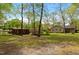 Spacious backyard with lush greenery, mature trees, and a shed, offering a serene outdoor space at 714 W J St, Erwin, NC 28339