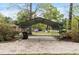 Large, metal carport provides ample covered parking space, set amidst a lush, green landscape and mature trees at 714 W J St, Erwin, NC 28339