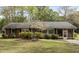 Charming brick home features manicured landscaping, a well-maintained lawn, and an inviting screened-in porch at 714 W J St, Erwin, NC 28339