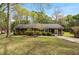Charming brick home features manicured landscaping, a well-maintained lawn, and an inviting screened-in porch at 714 W J St, Erwin, NC 28339
