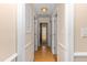 Bright hallway featuring hardwood floors, neutral walls, and multiple doorways offering access to various rooms in the home at 714 W J St, Erwin, NC 28339