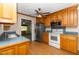 Functional kitchen with wood cabinets, stainless steel appliances, and a view into the living room at 714 W J St, Erwin, NC 28339