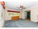 Cozy living room with gray carpet, a ceiling fan, and natural light from a large window at 714 W J St, Erwin, NC 28339