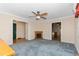 Living room featuring a ceiling fan, an electric fireplace, and multiple doorways to other rooms at 714 W J St, Erwin, NC 28339