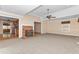 Open living room with a brick fireplace, ceiling fan, and views into the kitchen and hallway at 714 W J St, Erwin, NC 28339