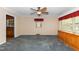 Bright living room with built-in cabinetry, a ceiling fan, and windows with views of the outdoors at 714 W J St, Erwin, NC 28339