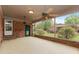Spacious sunroom with brick walls, ceiling fans, and serene outdoor views, perfect for relaxation and entertaining at 714 W J St, Erwin, NC 28339