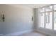 Minimalist bedroom with natural light through large windows, and a wall awaiting final paint color at 7412 Wexford Woods Ln, Wake Forest, NC 27587