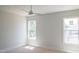 This bedroom has a ceiling fan and two windows that let in lots of natural light at 7412 Wexford Woods Ln, Wake Forest, NC 27587