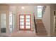 Bright foyer featuring a modern double door entry and staircase, all awaiting finishing touches at 7412 Wexford Woods Ln, Wake Forest, NC 27587