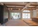 Bright living room with wood beam ceilings, large windows, and a modern fireplace, awaiting final touches at 7412 Wexford Woods Ln, Wake Forest, NC 27587