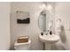 Elegant powder room features pedestal sink, oval mirror, and stylish decorative touches at 85 Sunshine Rd # 4, Kenly, NC 27542