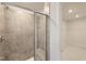 Tiled shower with glass door, bench seating, and nearby walk-in closet at 85 Sunshine Rd # 4, Kenly, NC 27542