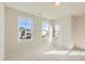 Bright bedroom featuring neutral carpeting, ample natural light, and views of the neighborhood at 85 Sunshine Rd # 4, Kenly, NC 27542