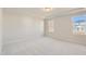 Sun-filled bedroom features neutral carpet, tray ceiling, and ample natural light at 85 Sunshine Rd # 4, Kenly, NC 27542