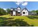 Rear view of a new construction home with a spacious yard and an inviting screened-in porch at 8621 Bishop Pine Ln, Wake Forest, NC 27587